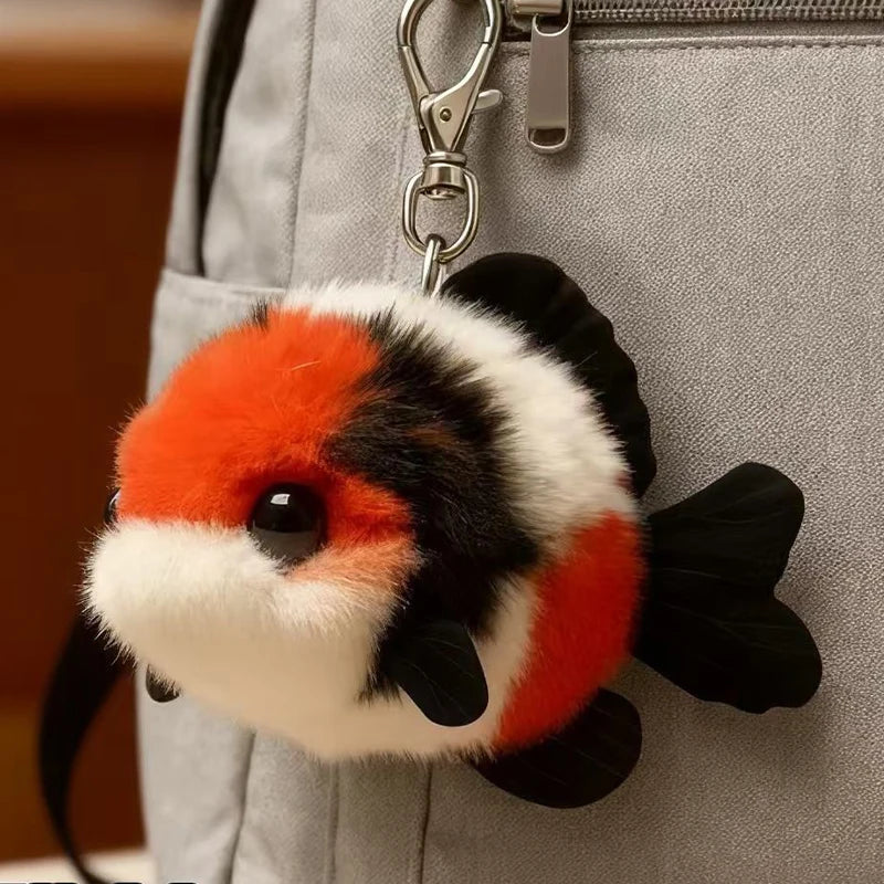 Plush koi fish keychain attached to a gray bag