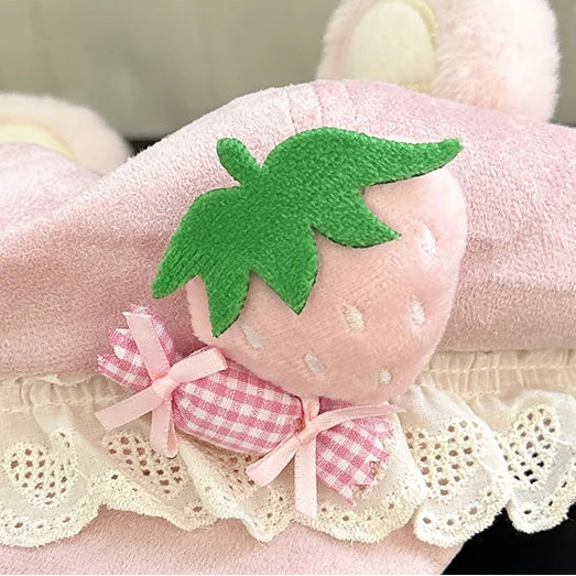 Pink plush strawberry with green leaf and pink bow on a hat