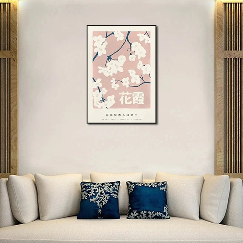 Framed artwork with floral design on a wall above a sofa with decorative pillows.