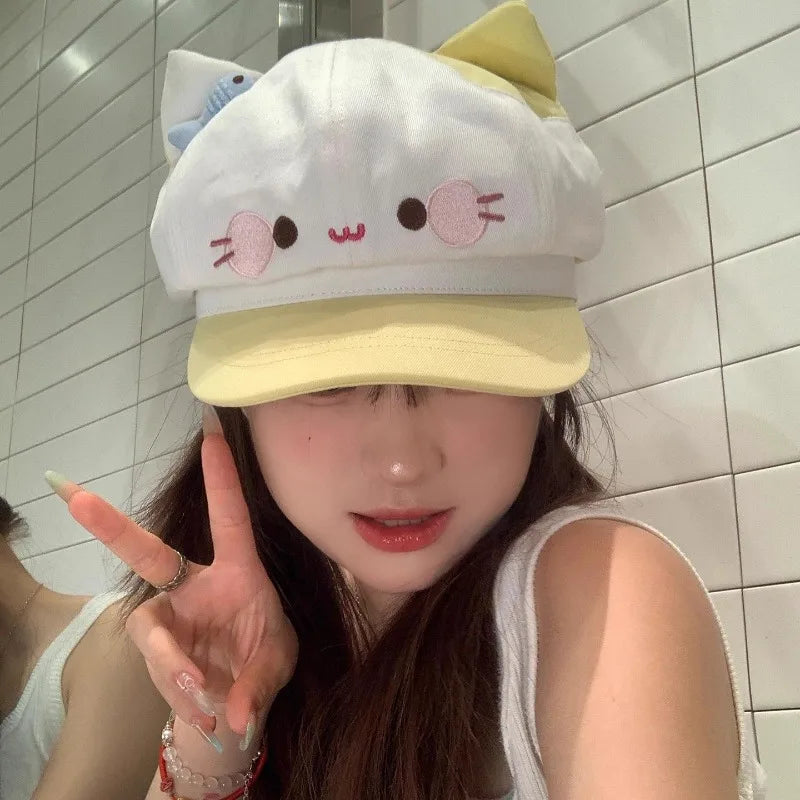 Person wearing a cartoonish white and yellow cap with cat ears in a bathroom.