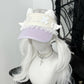 Visor with unicorn design and white hair on a mannequin head against a neutral background