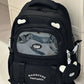 beary cute backpack with bear ears and a visible brand logo against a white door , black version