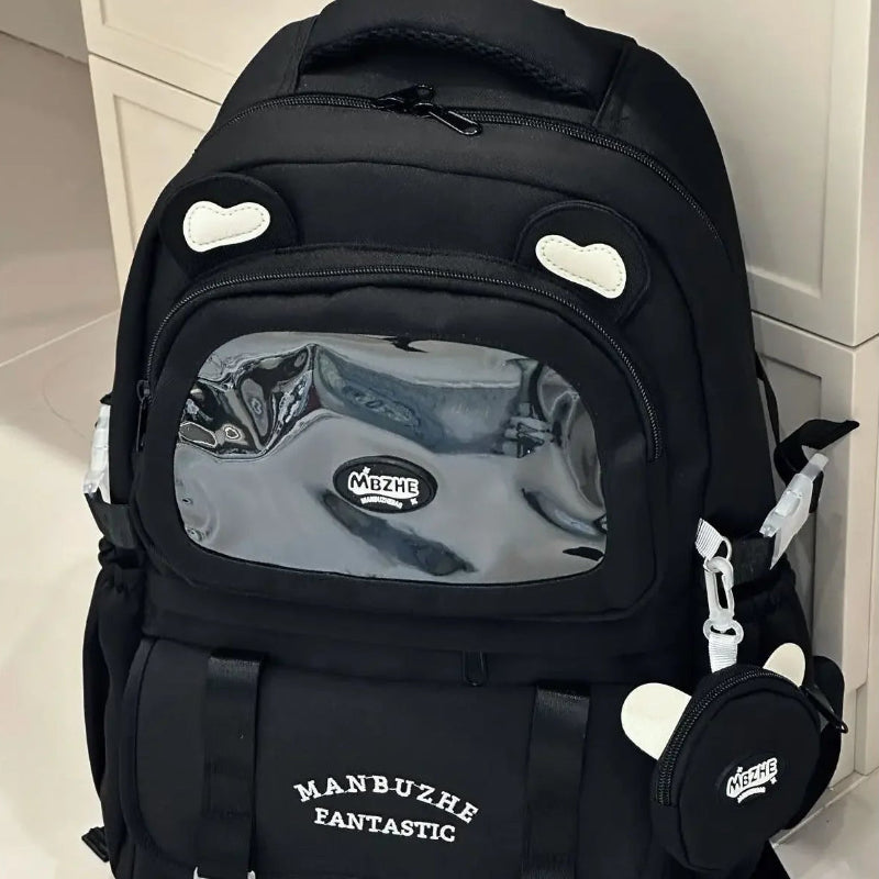 beary cute backpack with bear ears and a visible brand logo against a white door , black version