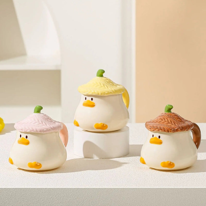 Kawaii Duck Mugs with lids on a countertop