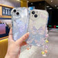 Clear phone cases with butterfly designs held by a hand in an indoor setting. One butterfly case has hints of blue into the case and butterfly design while the other just has it in the background and the butterfly is outlined with gold glitter