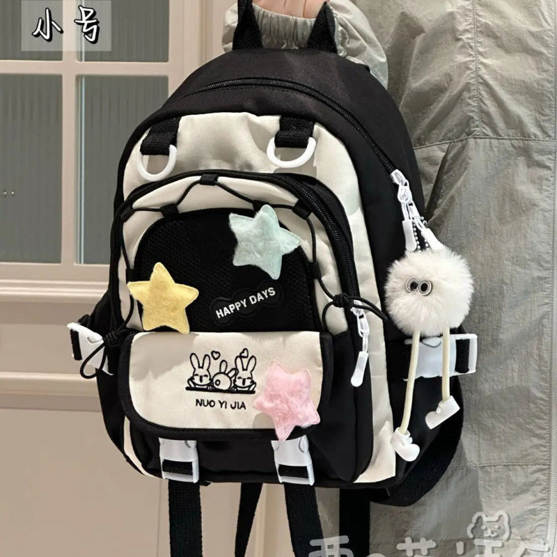 Kawaii backpack with multiple pockets being held by a person