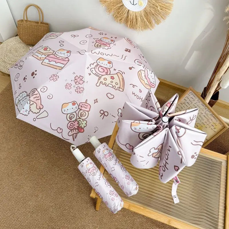 Set of cat-themed umbrellas and cases on a wooden surface.