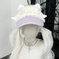 White cat ear hat with decorative elements on a mannequin head with white wig.