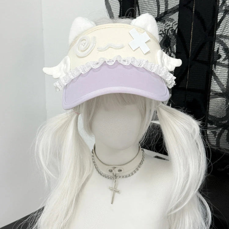 White cat ear hat with decorative elements on a mannequin head with white wig.