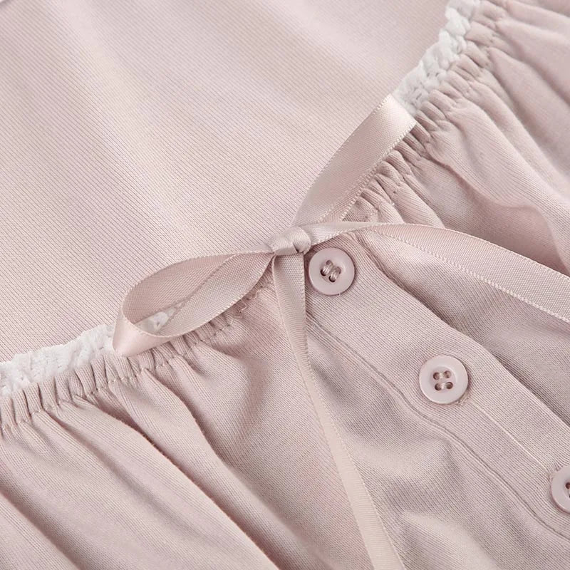 Close up of Bow above buttons on a pink blouse