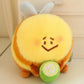 kawaii bee plushie sitting on a cream color desk