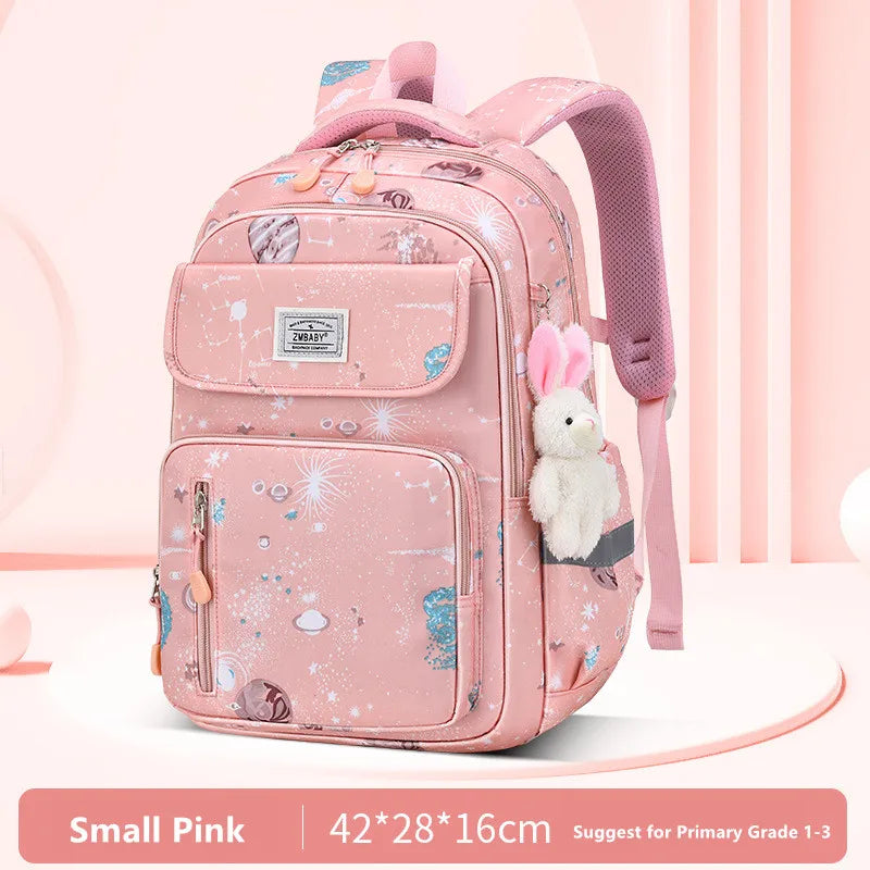 Pink backpack with teddy bear plush toy on a light pink background