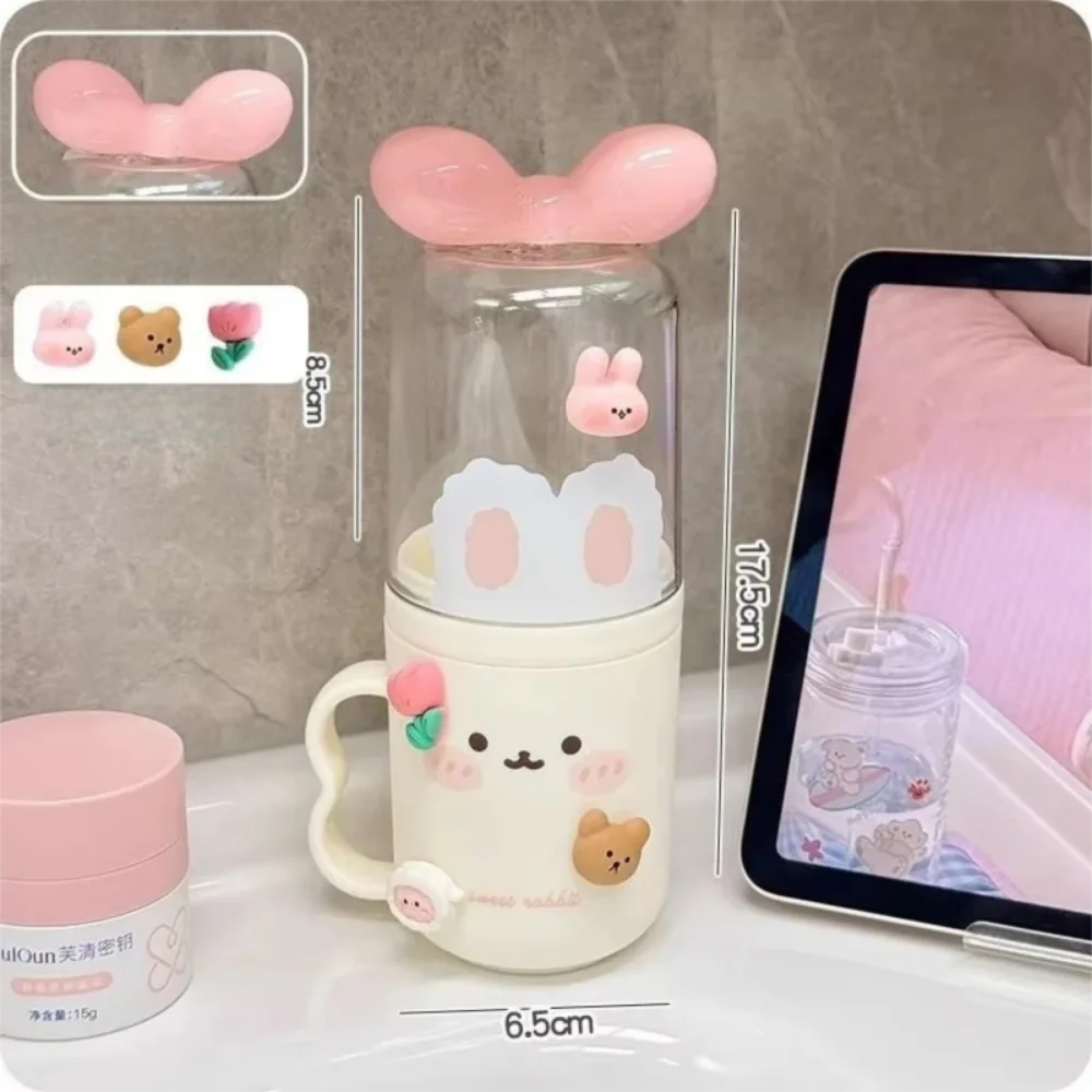 Kawaii pink toothbrush holder with bunny ears, displayed on a gray surface.