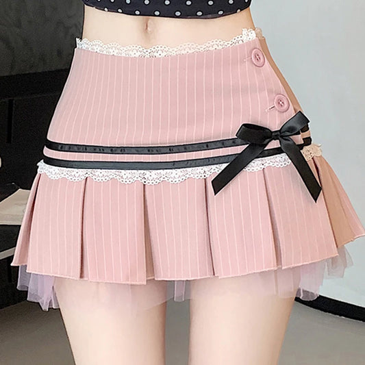 Pink pleated skirt with a black ribbon and lace trim worn by a person.