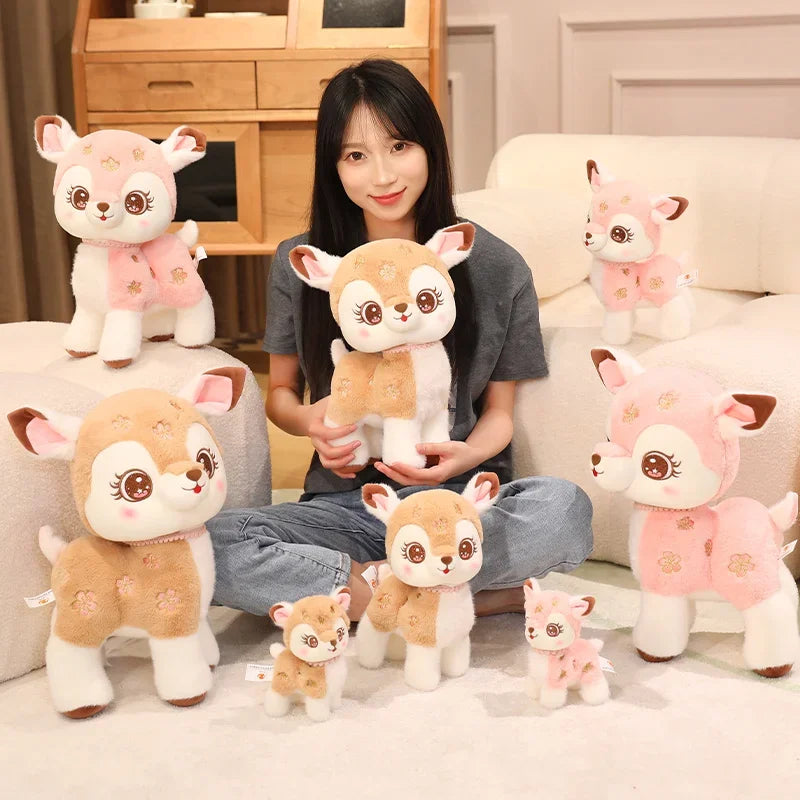 woman surrounded by deer plushies in pink and brown and different sizes.