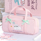 Pink pencil bag with cat design and bows on a light background