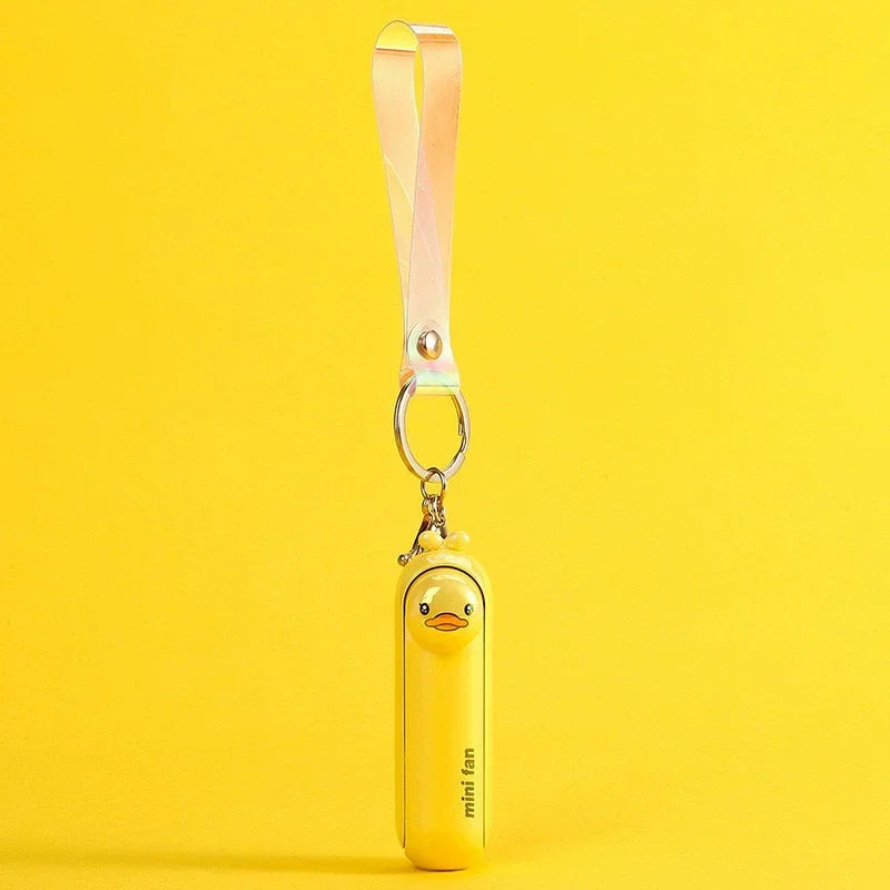 Yellow handheld fan with duck design and keychain on a yellow background