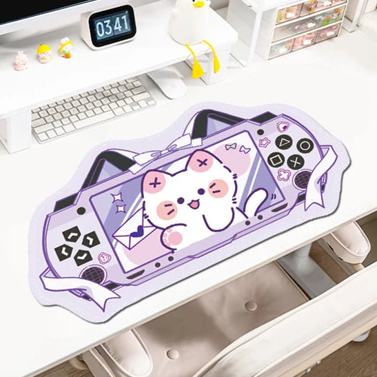 Desk setup with a computer, mouse pad, and decorative items on a white surface.