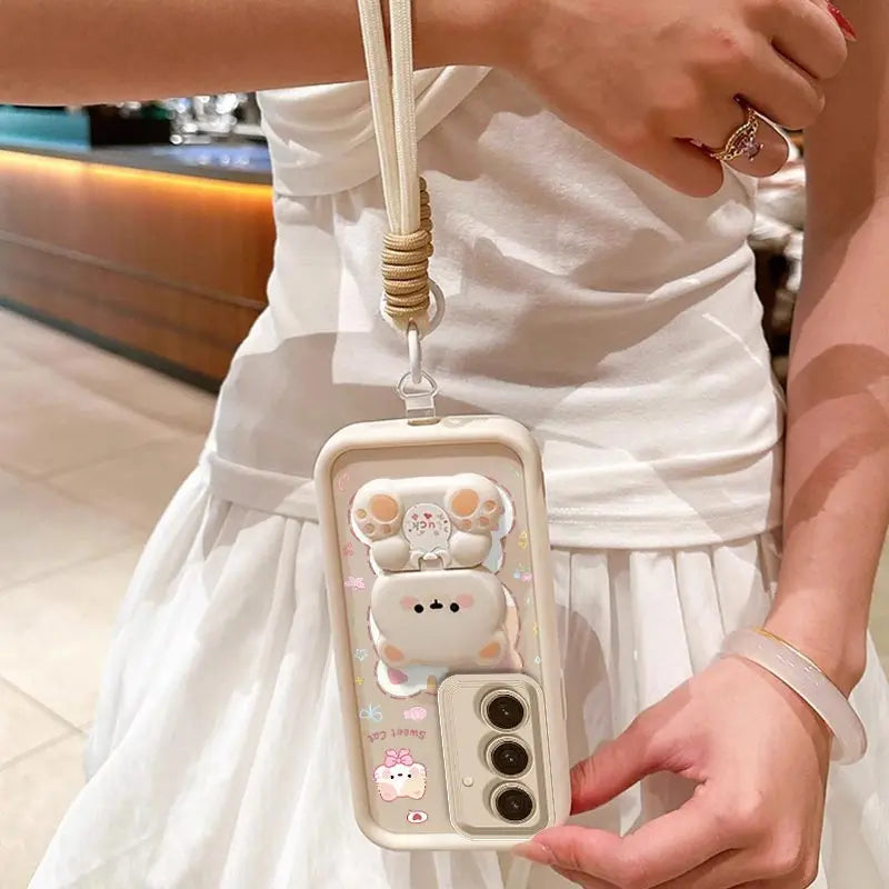 This woman is demonstrating the wrist strap that comes with the  Kawaii Cuties Samsung Phone Case. 