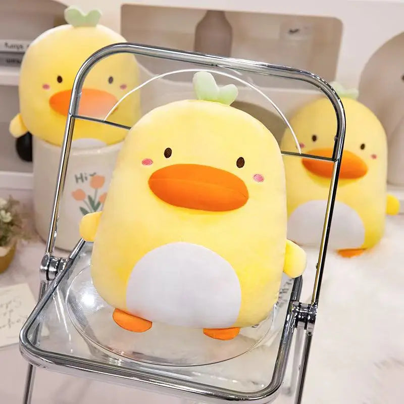 A Kawaii Derpy Duck Plushie sat on a small foldable perspex chair with a metal frame, with its derpy duck army behind it.