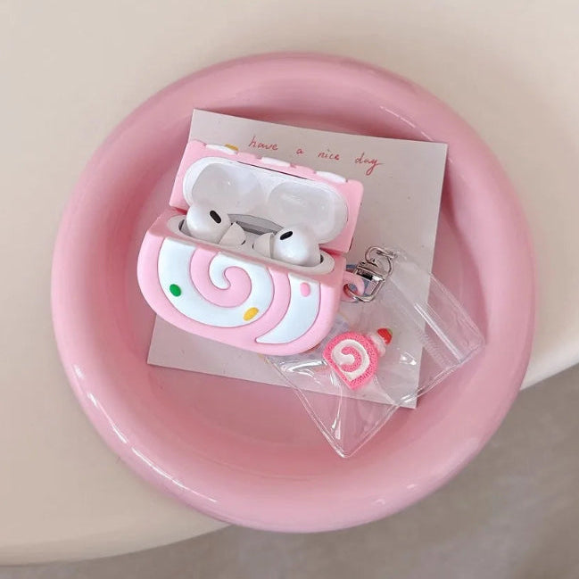 Pink swiss roll shaped air pod case on a pink plate