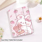 kawaii Strawberry Bunny & Coffee iPad Case, this case depicts a bunny winking while holding a coffee in its paws, with strawberries raining down, the main color is pastel pink with a white rabbit. this case is displayed on a white desk top.