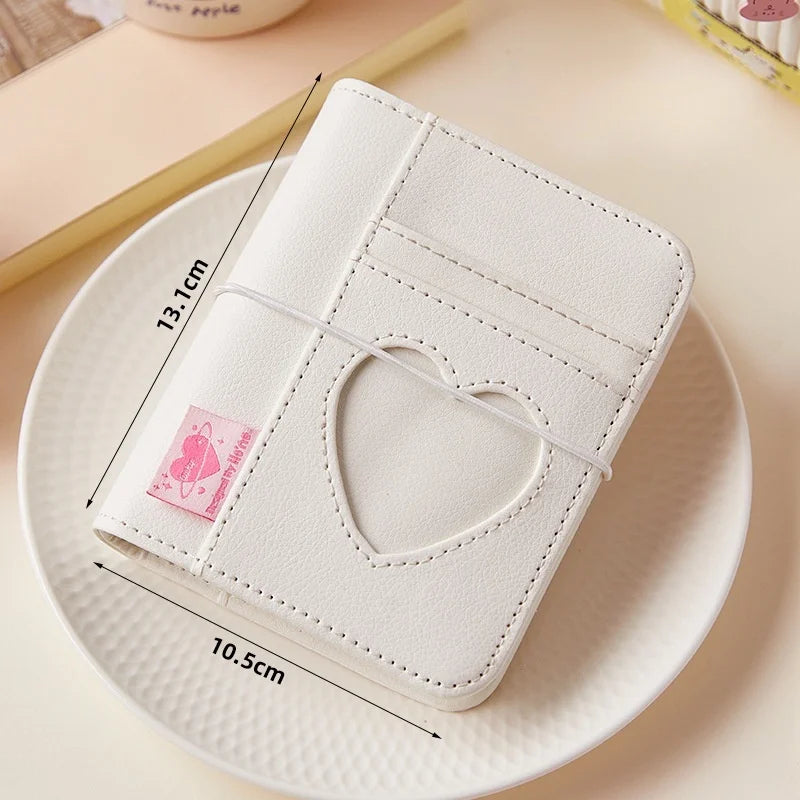 White PU Leather album with heart cutout on a plate