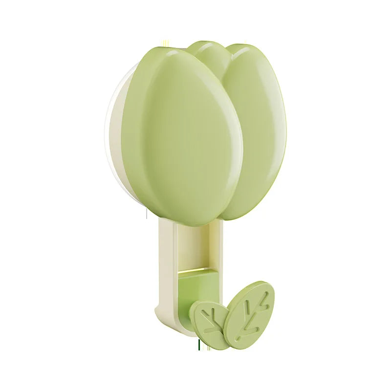 Green wall hook with leaf design on a white background