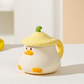Kawaii Duck Mug with yellow Lid on countertop