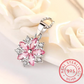 Sakura Cherry Blossom Necklace the hot pink version is displayed on a pastel pink cloth slightly crumpled up to display the pendant more effectively.