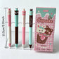 Set of four kawaii-themed pens with a packaging box on a white background