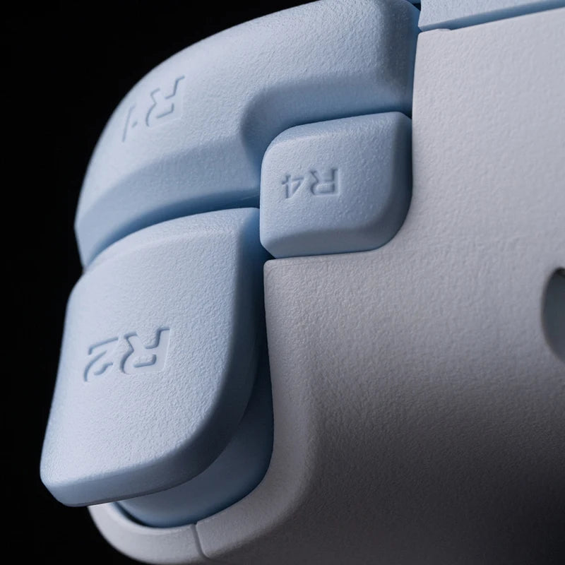 Close-up of a light blue gaming controller with 'R4' buttons on a black background