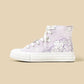A single high-top sneaker in light lavender purple canvas with white floral illustrations and white laces, shown in profile against a solid beige background.