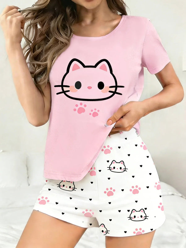 Person wearing a pink top with a kawaii cat face design and white shorts with cat print on a light background