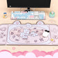 Desk setup with a keyboard, mouse, and decorative mouse pad featuring cartoon characters.