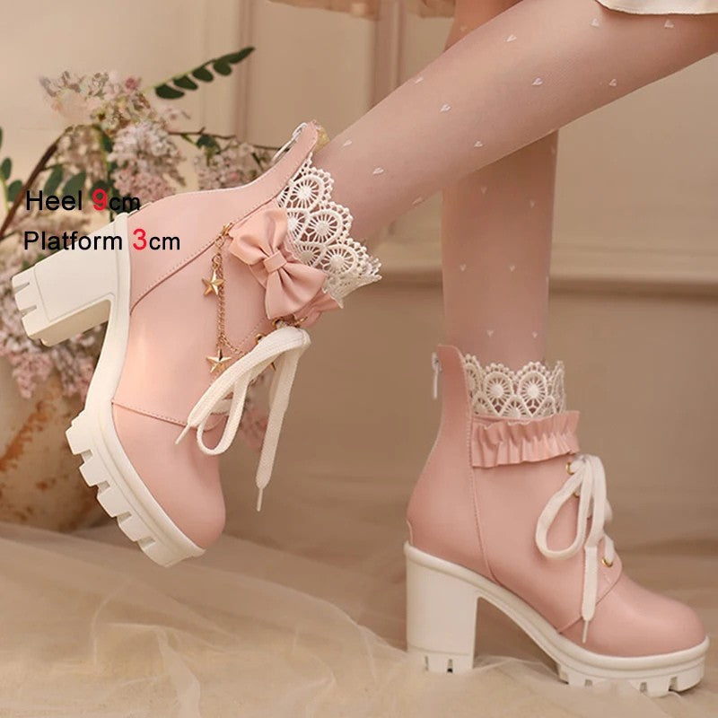 Pink platform boots with lace details worn by a person, on a neutral background.