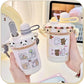Two cute water bottles with cartoon designs held by hands against a blurred background.