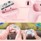 Pink gaming controller with close-up details and hands holding it in front of a screen.