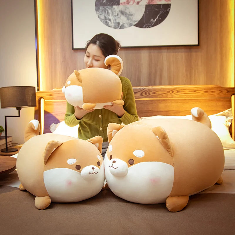 Woman holding a large plush dog toy in a cozy room.