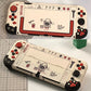 Two handheld gaming consoles with cartoon character design on a checkered surface.