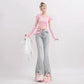 Person wearing a pink top and jeans with pink accessories on a white background