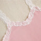 Pink fabric with white lace trim on a beige background