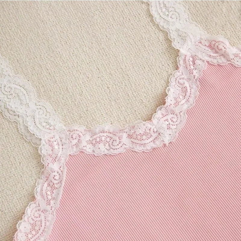 Pink fabric with white lace trim on a beige background