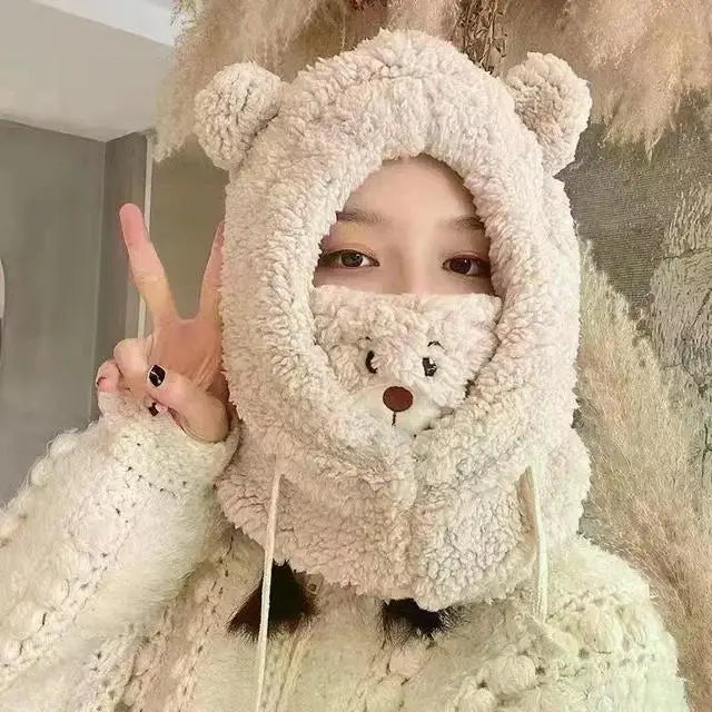 Person wearing a fluffy bear-themed hat with a teddy bear face design.