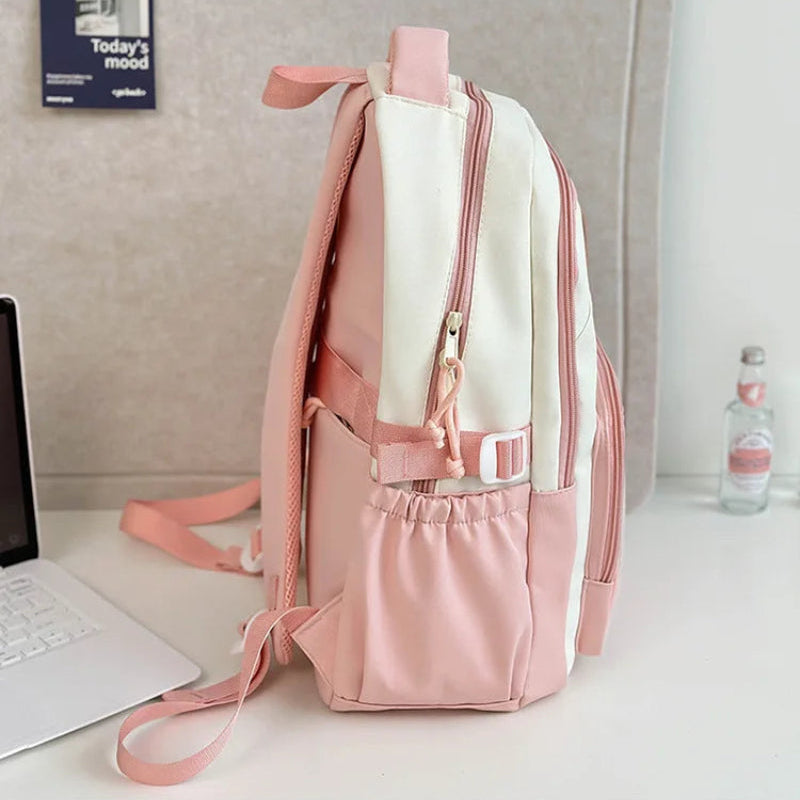 pink neko backpack displayed by a white wall sideways