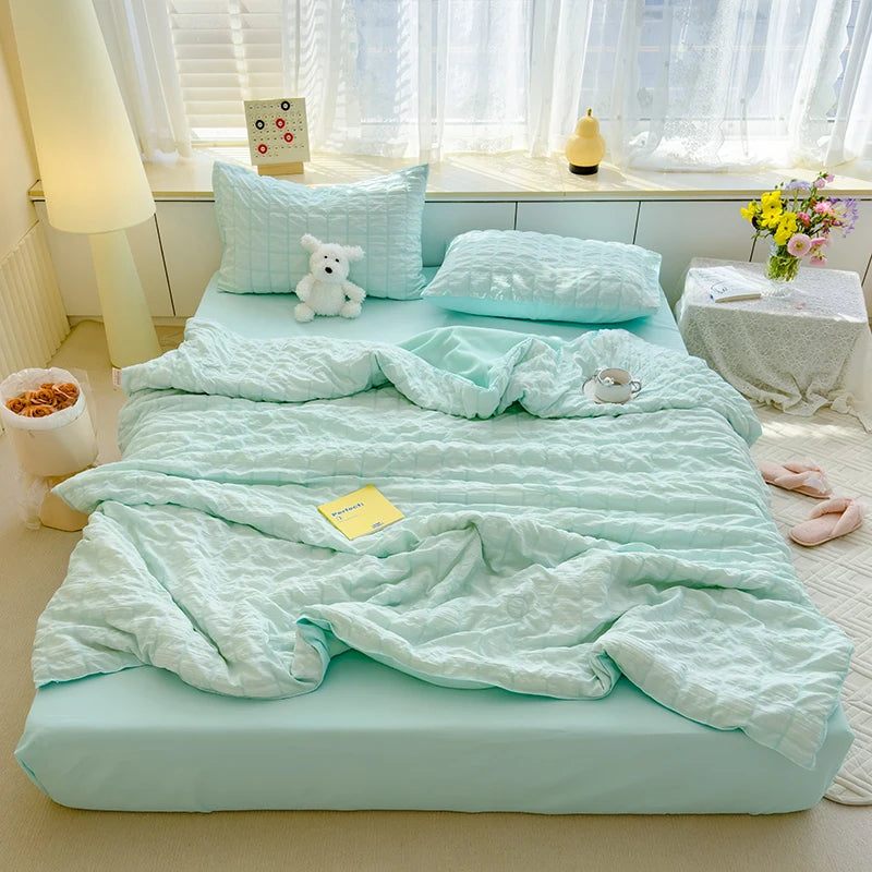 Blue  seersucker duvet set displayed on bed.