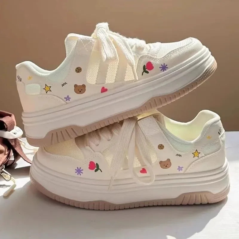 Kawaii white sneakers with colorful designs on a light background