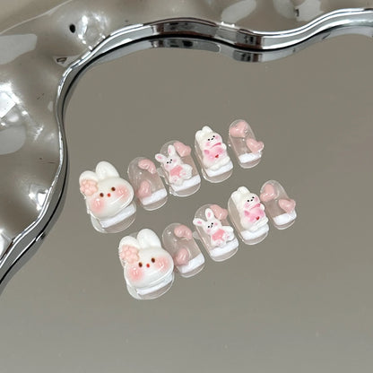 Set of 10 kawaii bunny press on nails on a mirrored surface.
