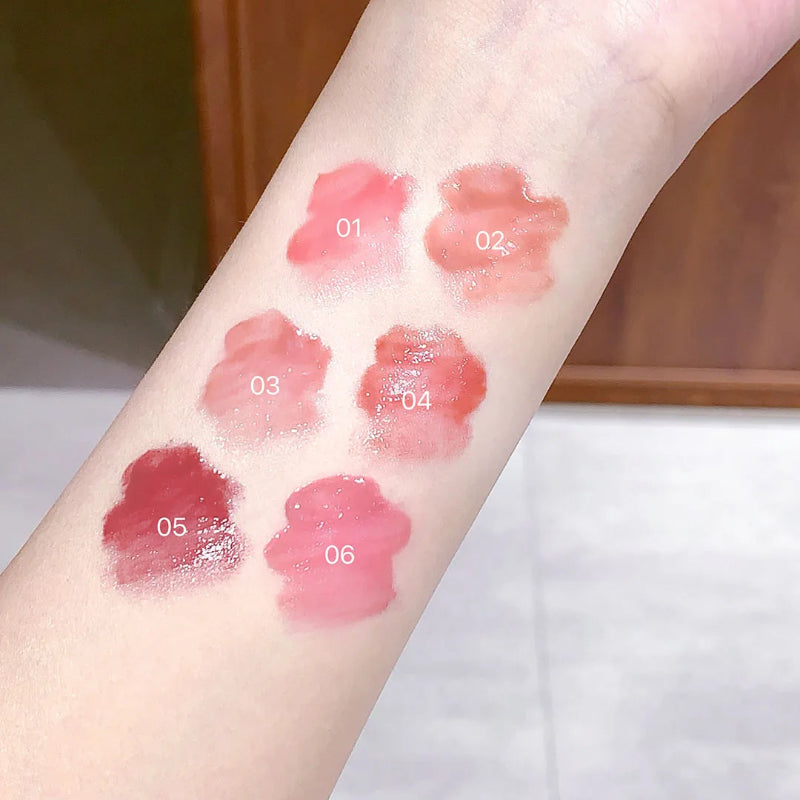 women displaying different lip gloss shades from the kawaii butterfly lip gloss collection on her forearm
