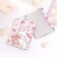 kawaii Strawberry Bunny & Coffee iPad Case, this case depicts a bunny winking while holding a coffee in its paws, with strawberries raining down, the main color is pastel pink with a white rabbit. this case is displayed on a white desk top.